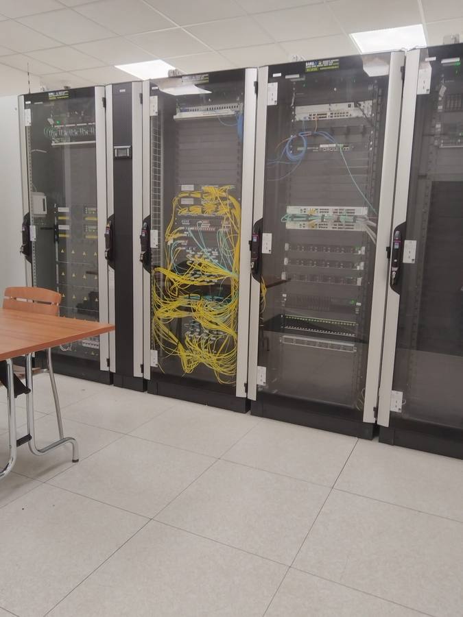 Data center racks with fiber and copper patching