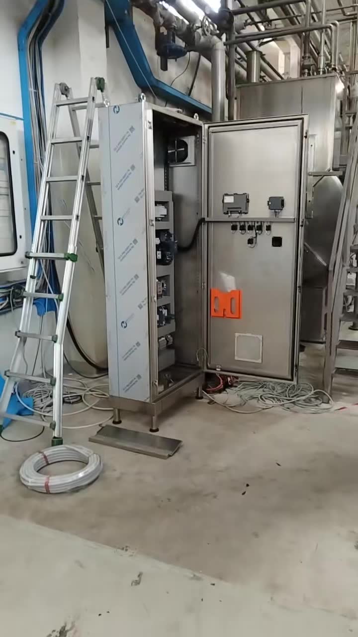 Stainless steel control cabinet at a processing machine in a tomato juice factory