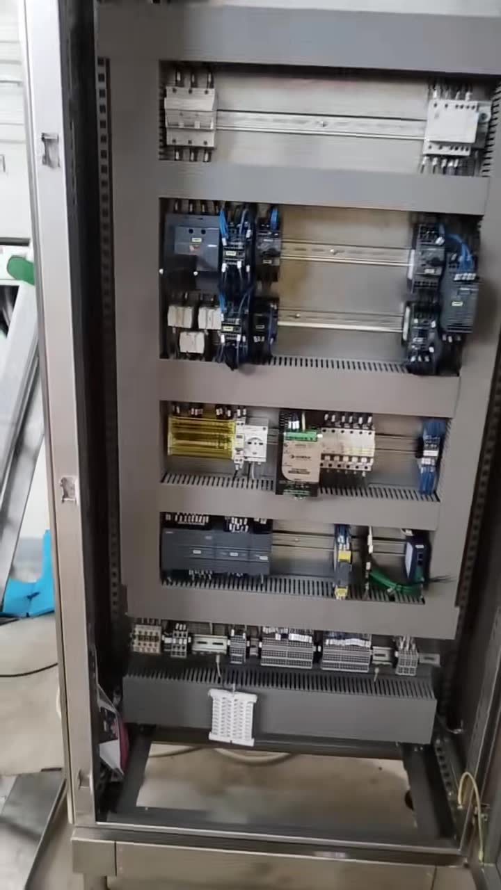 Wired interior of the stainless steel cabinet: drive, breakers, contactors and terminals